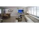 Comfortable living room with a large sectional sofa, entertainment center, and adjacent dining area at 4523 Clearwater Harbor S Dr, Largo, FL 33770