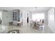 Open-concept living space with stylish decor, an entertainment center, and a dining area at 4523 Clearwater Harbor S Dr, Largo, FL 33770