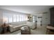 Cozy living room featuring shuttered windows, a neutral color palette, and comfortable seating arrangement at 4523 Clearwater Harbor S Dr, Largo, FL 33770