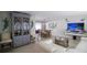 Open-concept living space with stylish decor, an entertainment center, and a dining area at 4523 Clearwater Harbor S Dr, Largo, FL 33770