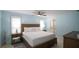 Light-filled main bedroom with blue walls, a large bed, and tasteful decorations, creating a relaxing atmosphere at 4523 Clearwater Harbor S Dr, Largo, FL 33770