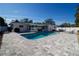 A stunning backyard featuring a luxurious private pool and beautiful, modern gray stone patio perfect for entertaining at 4523 Clearwater Harbor S Dr, Largo, FL 33770