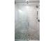 Modern shower with pebble flooring, glass door, and white tiled walls, offering a spa-like experience at 4523 Clearwater Harbor S Dr, Largo, FL 33770