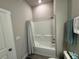 Clean bathroom with a tub, shower, and updated fixtures at 493 Omen St, Punta Gorda, FL 33982