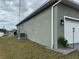 Side view of a house showcasing the AC unit and exterior wall at 493 Omen St, Punta Gorda, FL 33982