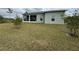 Rear view of house with large backyard and screened porch at 493 Omen St, Punta Gorda, FL 33982