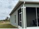 Exterior view of a one-story house with a screened porch and landscaped yard at 493 Omen St, Punta Gorda, FL 33982