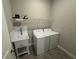 Convenient laundry room with washer, dryer, and utility sink at 493 Omen St, Punta Gorda, FL 33982