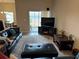 Living room with leather sofas, large TV, and access to patio at 493 Omen St, Punta Gorda, FL 33982