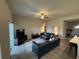 Spacious living room featuring leather sofas and a large TV at 493 Omen St, Punta Gorda, FL 33982