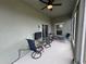 Relaxing screened porch with seating and ceiling fan at 493 Omen St, Punta Gorda, FL 33982
