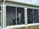 View of the house's screened porch from the outside at 493 Omen St, Punta Gorda, FL 33982