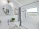 Clean bathroom with white tile, a shower/tub combo, and a vanity at 5214 25Th N Ave, St Petersburg, FL 33710