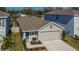 One story house, gray roof, two car garage, small front yard at 5322 Fiddle Fig Ave, Wimauma, FL 33598