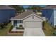 One-story house, gray roof, two-car garage, small front yard at 5322 Fiddle Fig Ave, Wimauma, FL 33598