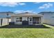View of home from the backyard with fence and lawn at 5322 Fiddle Fig Ave, Wimauma, FL 33598