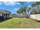 Backyard with a grassy lawn, picnic table, and home view at 5322 Fiddle Fig Ave, Wimauma, FL 33598
