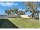 Fenced backyard, grassy area and picnic table at 5322 Fiddle Fig Ave, Wimauma, FL 33598