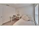 Well-lit bedroom with a bed and workspace at 5322 Fiddle Fig Ave, Wimauma, FL 33598