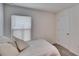 Cozy bedroom with a bed and window at 5322 Fiddle Fig Ave, Wimauma, FL 33598