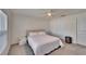 Cozy bedroom with a full-size bed, nightstand and window with blinds at 5322 Fiddle Fig Ave, Wimauma, FL 33598