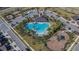 Aerial view showing resort-style pool, playground, and community clubhouse at 5322 Fiddle Fig Ave, Wimauma, FL 33598