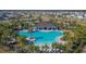 Aerial view of community pool with clubhouse and lush landscaping at 5322 Fiddle Fig Ave, Wimauma, FL 33598