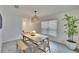 Dining area with a light wood table and woven pendant light at 5322 Fiddle Fig Ave, Wimauma, FL 33598