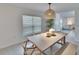 Light and airy dining area with wood table and seating at 5322 Fiddle Fig Ave, Wimauma, FL 33598