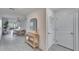 Bright entryway with light wood console table and mirror at 5322 Fiddle Fig Ave, Wimauma, FL 33598