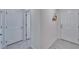 Clean hallway with tile floors and two doors at 5322 Fiddle Fig Ave, Wimauma, FL 33598
