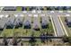 Aerial view of row of houses with backyards and landscaping at 5322 Fiddle Fig Ave, Wimauma, FL 33598