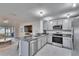 Modern kitchen with stainless steel appliances and granite countertops at 5322 Fiddle Fig Ave, Wimauma, FL 33598