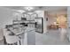 Open concept kitchen with granite island and stainless steel appliances at 5322 Fiddle Fig Ave, Wimauma, FL 33598