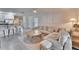 Spacious living area with sectional sofa and access to backyard at 5322 Fiddle Fig Ave, Wimauma, FL 33598