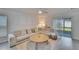 Living room with sectional sofa and sliding glass doors to patio at 5322 Fiddle Fig Ave, Wimauma, FL 33598