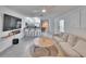Open concept living room with kitchen views, island seating, and a comfortable sofa at 5322 Fiddle Fig Ave, Wimauma, FL 33598