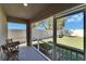 Relaxing screened porch with backyard view and table at 5322 Fiddle Fig Ave, Wimauma, FL 33598