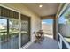 Bright screened porch, view of backyard and patio furniture at 5322 Fiddle Fig Ave, Wimauma, FL 33598