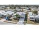 Aerial view of a charming home with a large driveway and well-kept lawn in a quiet neighborhood at 5539 Regal Way, Zephyrhills, FL 33541