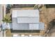 Top-down perspective of a property with metal roof, showcasing its layout and position within a residential area at 5539 Regal Way, Zephyrhills, FL 33541