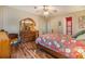 Comfortable bedroom with hardwood floors, floral bedding, and ample natural light at 5539 Regal Way, Zephyrhills, FL 33541