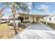 Beautiful home featuring a covered patio, well-kept lawn, and convenient carport at 5539 Regal Way, Zephyrhills, FL 33541