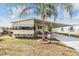 Lovely home with a carport, inviting patio, and attractive landscaping at 5539 Regal Way, Zephyrhills, FL 33541