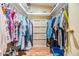 Organized walk-in closet with shelving, hanging rods and wood flooring maximizes storage space at 5539 Regal Way, Zephyrhills, FL 33541