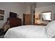 Spacious bedroom with a queen bed and access to a hallway at 5565 Salem Square N Dr, Palm Harbor, FL 34685