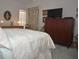 Bedroom featuring a queen-size bed, dresser, and TV at 5565 Salem Square N Dr, Palm Harbor, FL 34685
