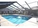Inviting community pool with covered patio and ample seating at 5565 Salem Square N Dr, Palm Harbor, FL 34685