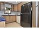Updated kitchen with stainless steel refrigerator and ample cabinet space at 5565 Salem Square N Dr, Palm Harbor, FL 34685