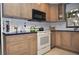 Modern kitchen with updated cabinetry, stainless steel appliances, and granite countertops at 5565 Salem Square N Dr, Palm Harbor, FL 34685
